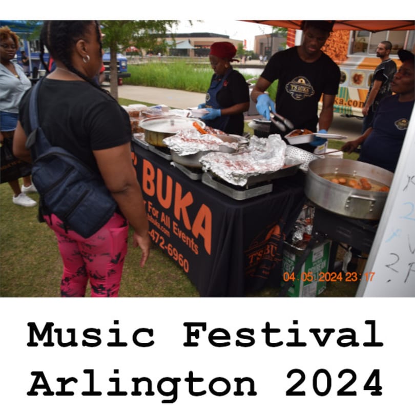 T's Buka food stall at a festival, with staff serving African cuisine from foil-covered trays.